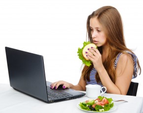 pretty female student with laptop. isolated over white